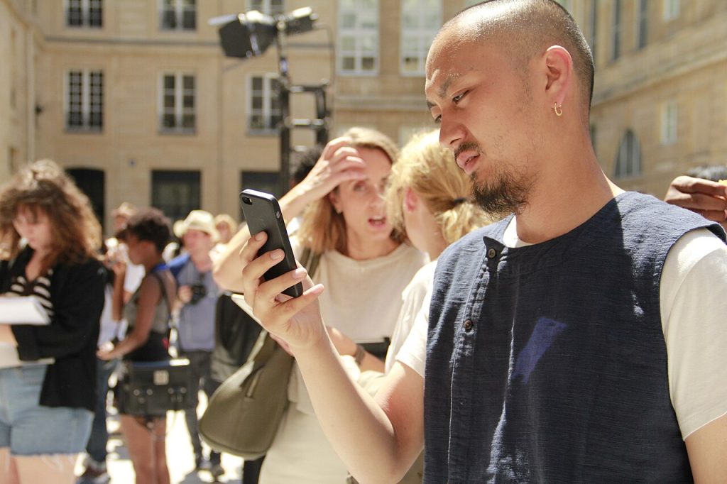 Man checking his smartphone during a gathering