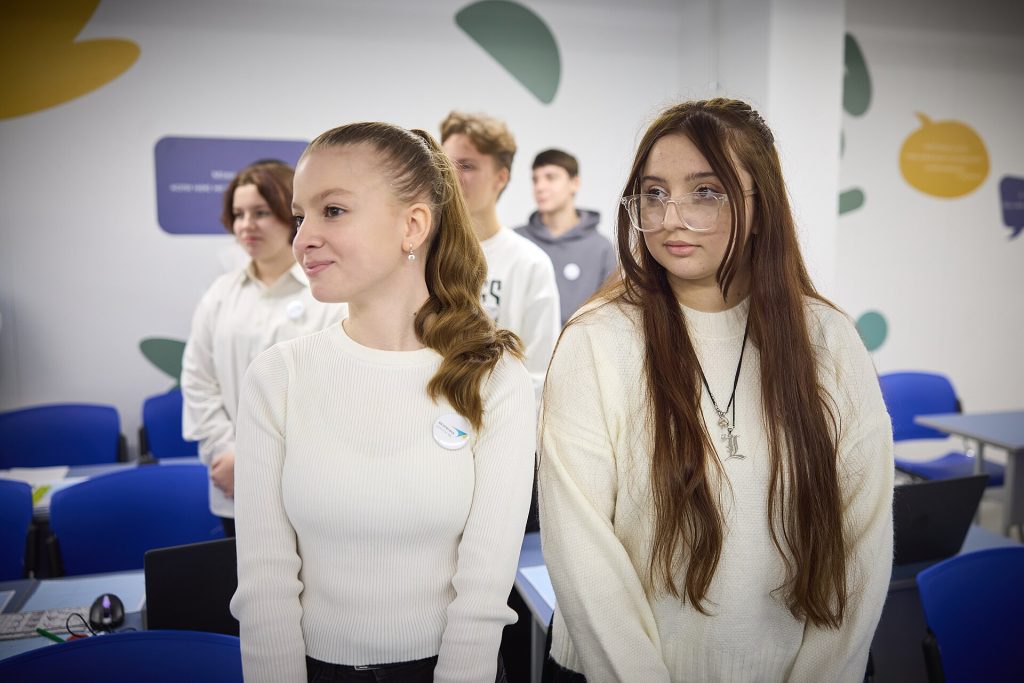 Students in a phone-free classroom focusing on a lesson while smartphones stay put away