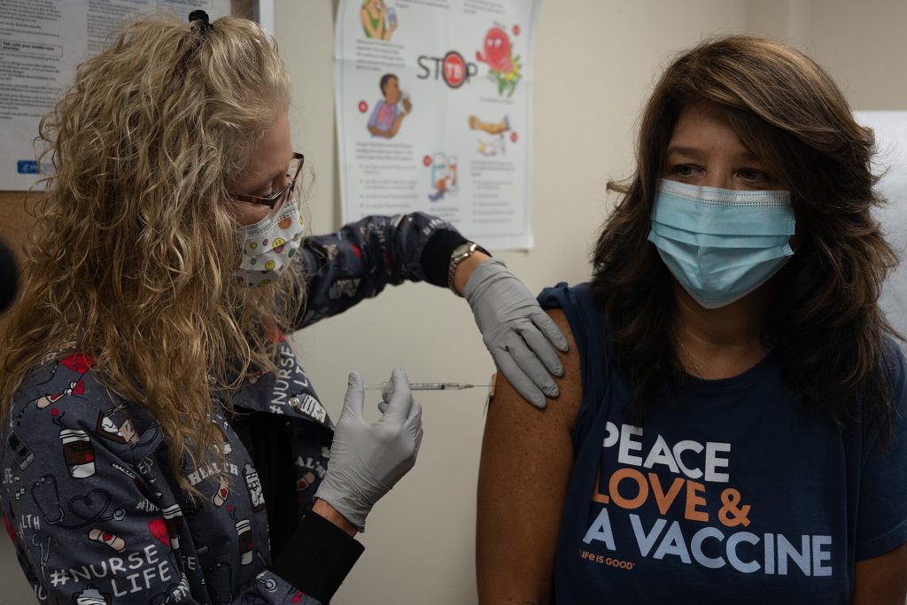 A healthcare worker preparing a measles vaccination dose at a clinic